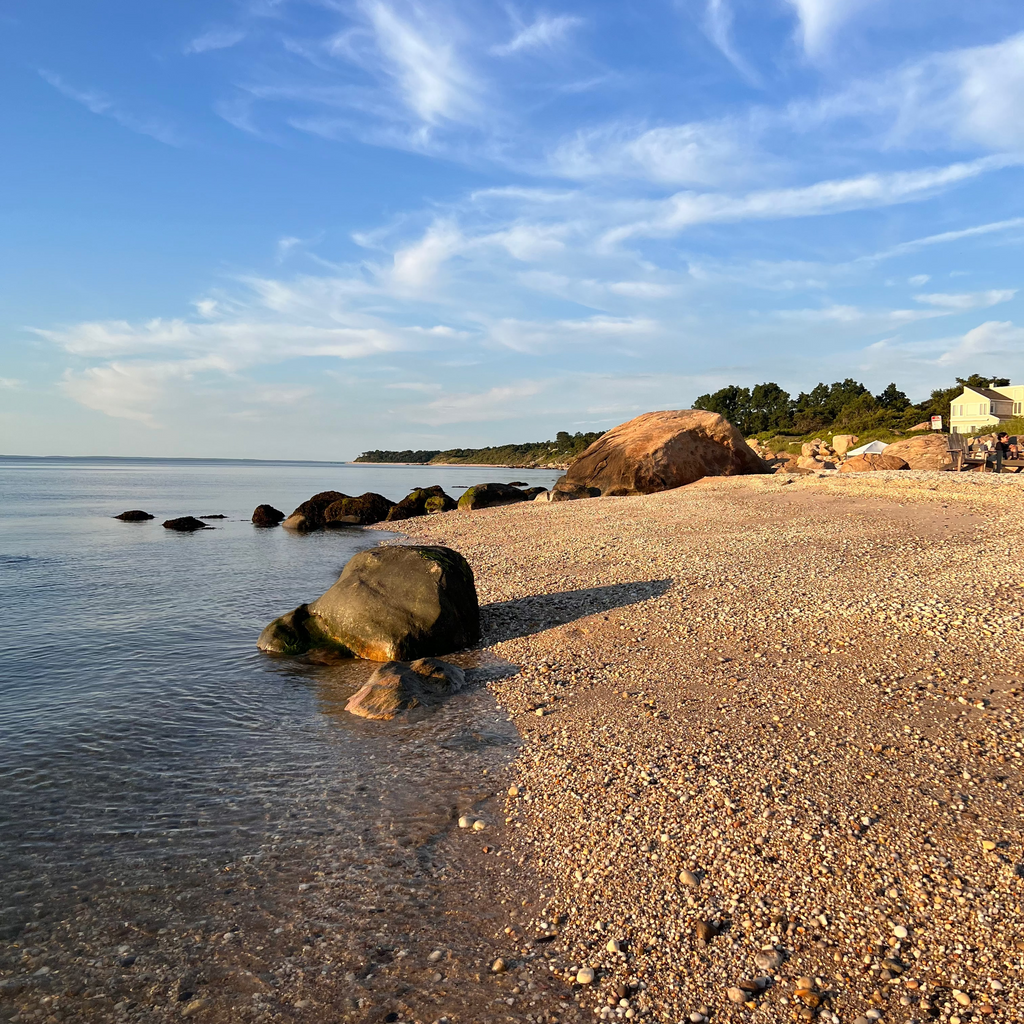 Beach scene with rocks and clear sky