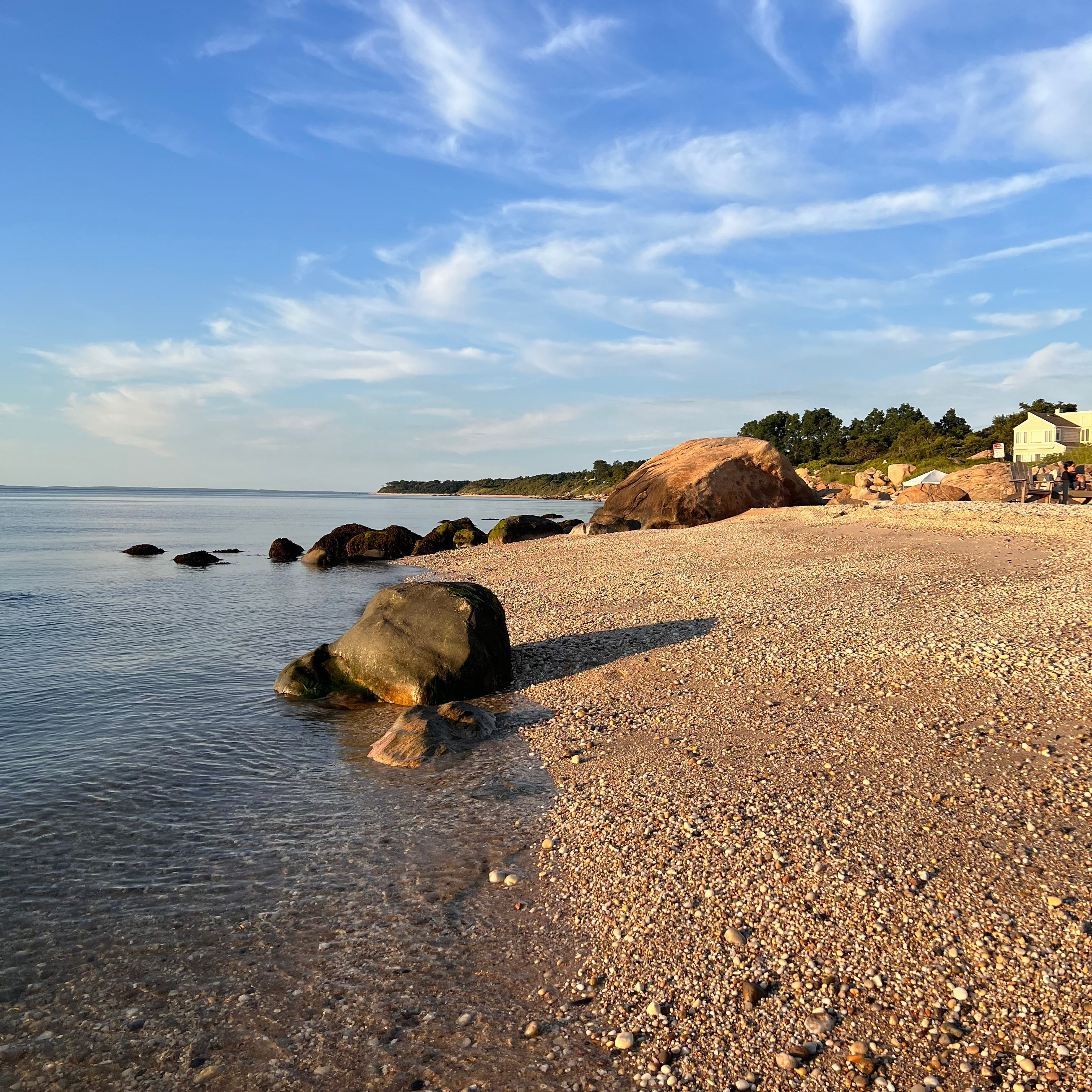 Beach scene with rocks and clear sky